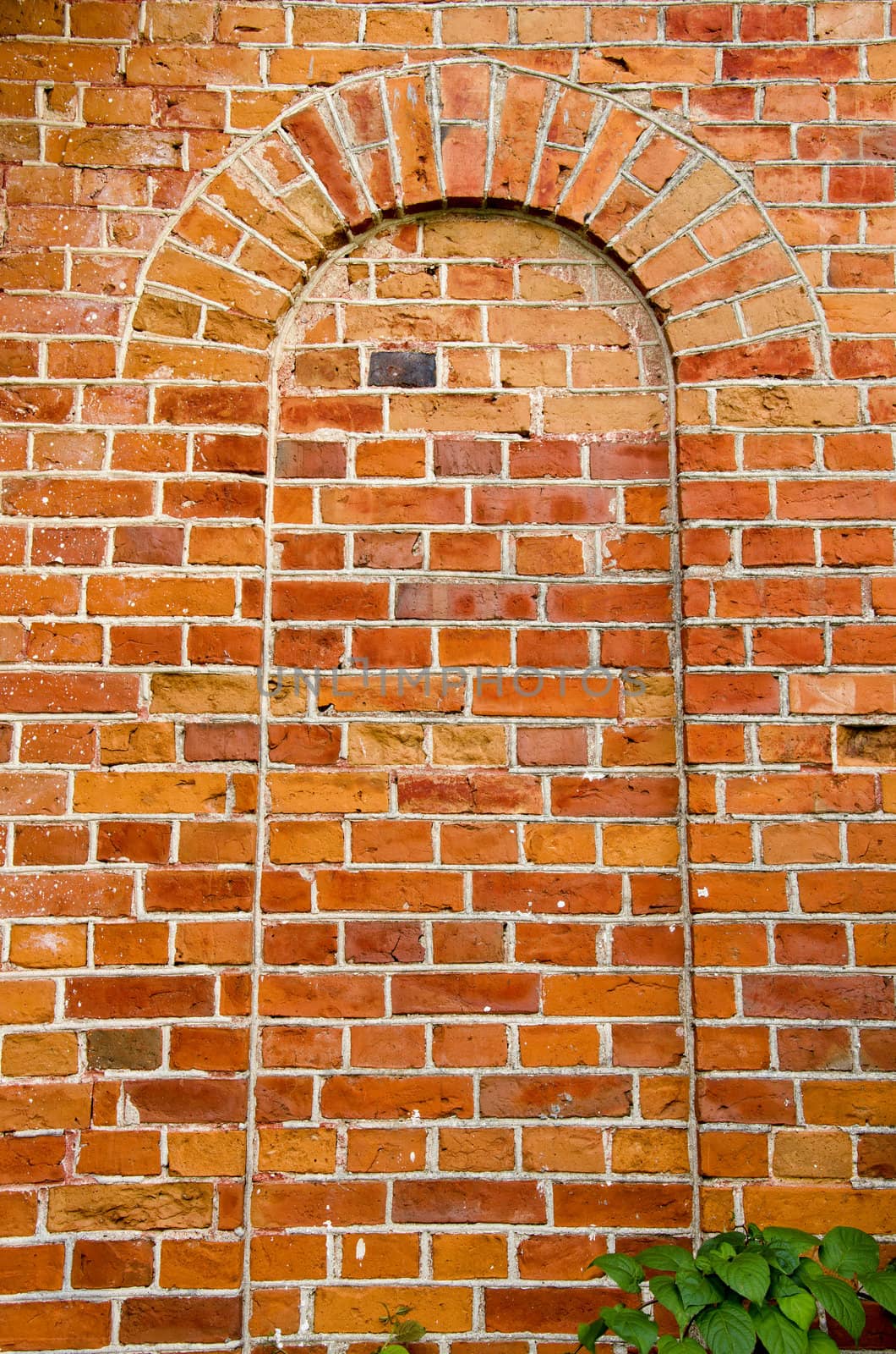 Background of ancient red brick wall arch imitation. Architectural backdrop details.