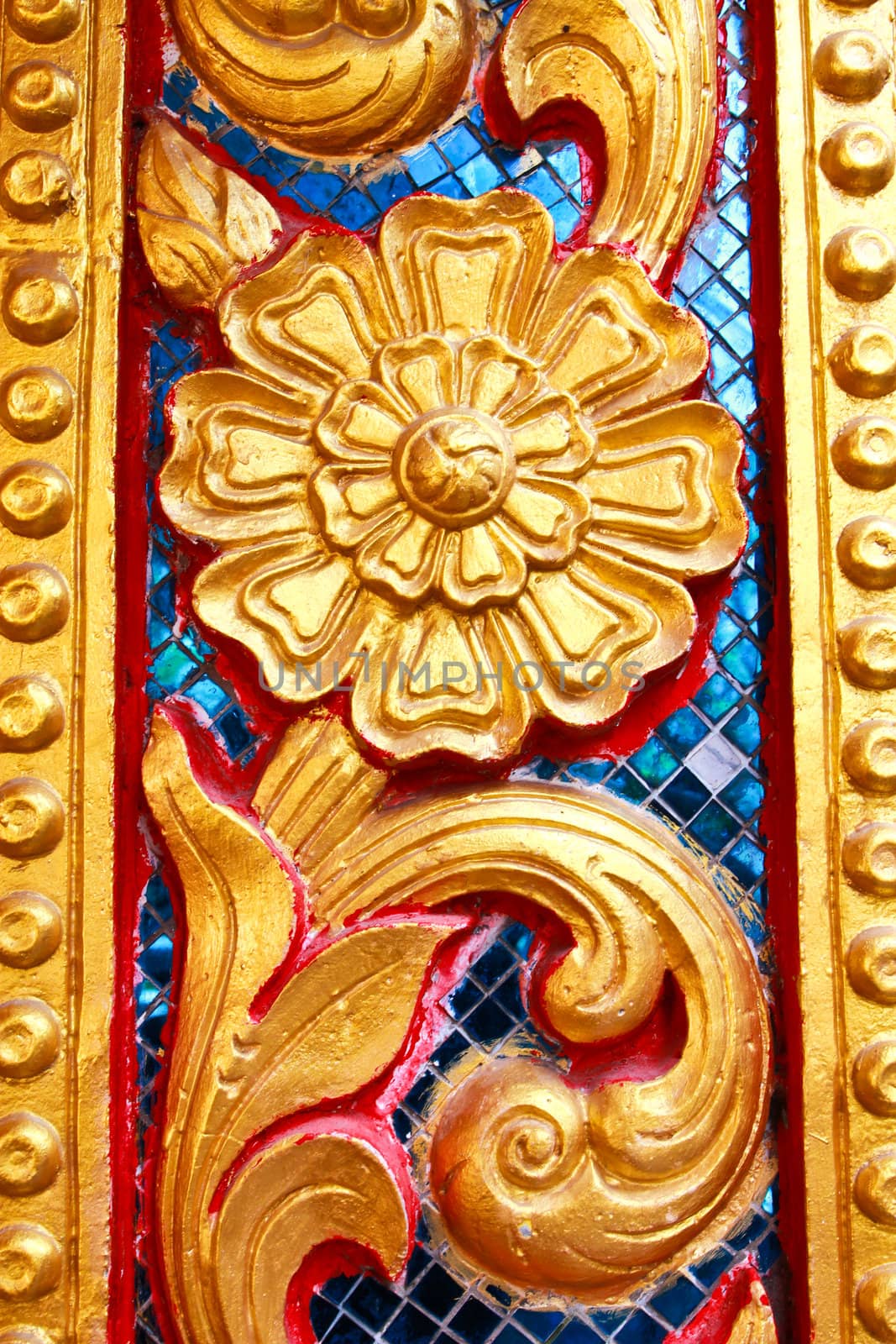 Golden Thai pattern design on temple wall