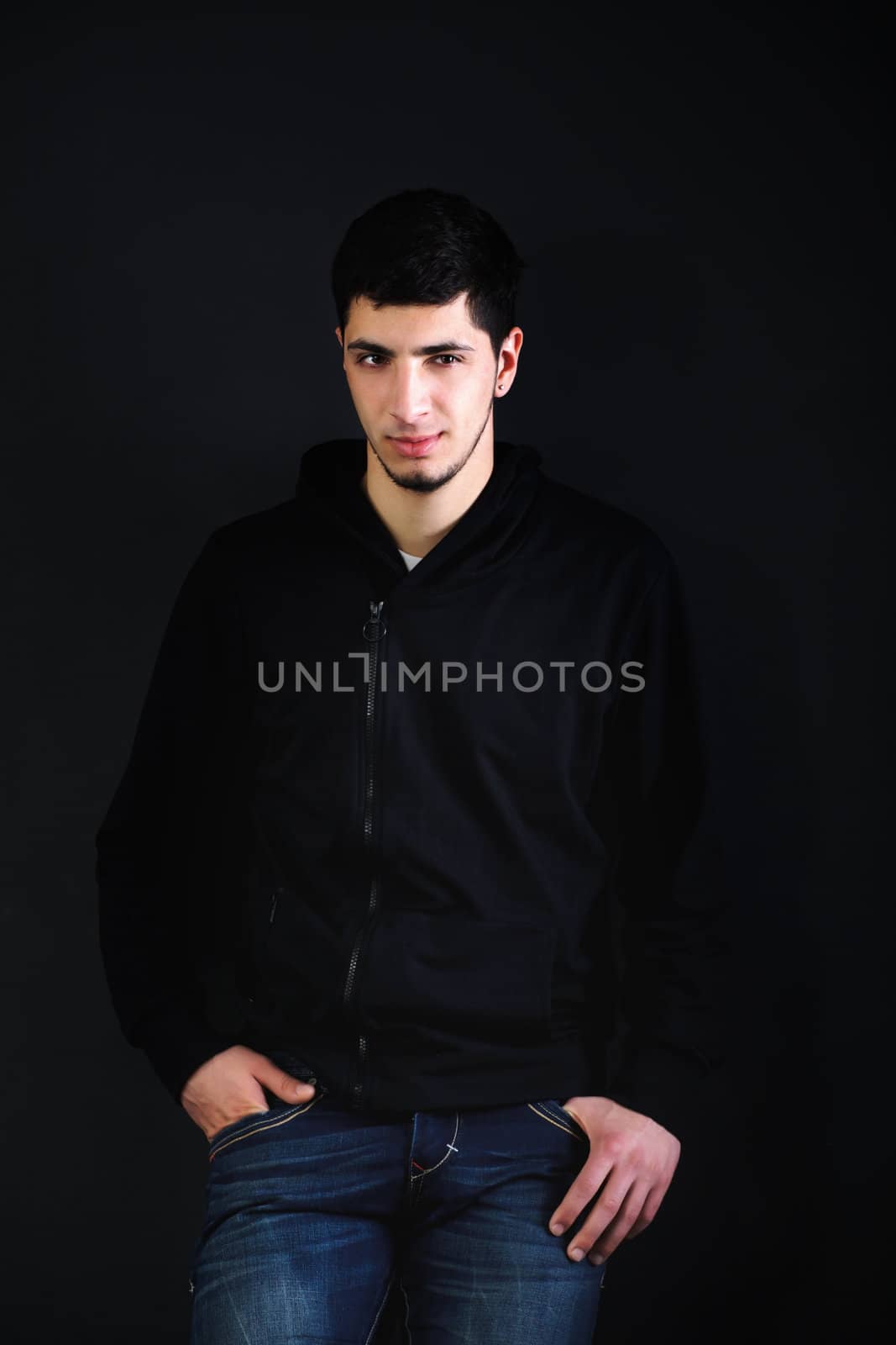 Portrait of a young man in the studio.  Toned, hard light is applied to achieve an artistic effect.