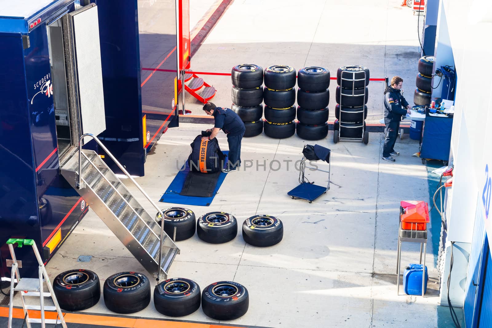 JEREZ DE LA FRONTERA, SPAIN - FEB 06: Mechanics of the team Toro Rosso preparing pneumatic tires Pirelli  for the start of the trainings on February 06 , 2012, in Jerez de la Frontera , Spain