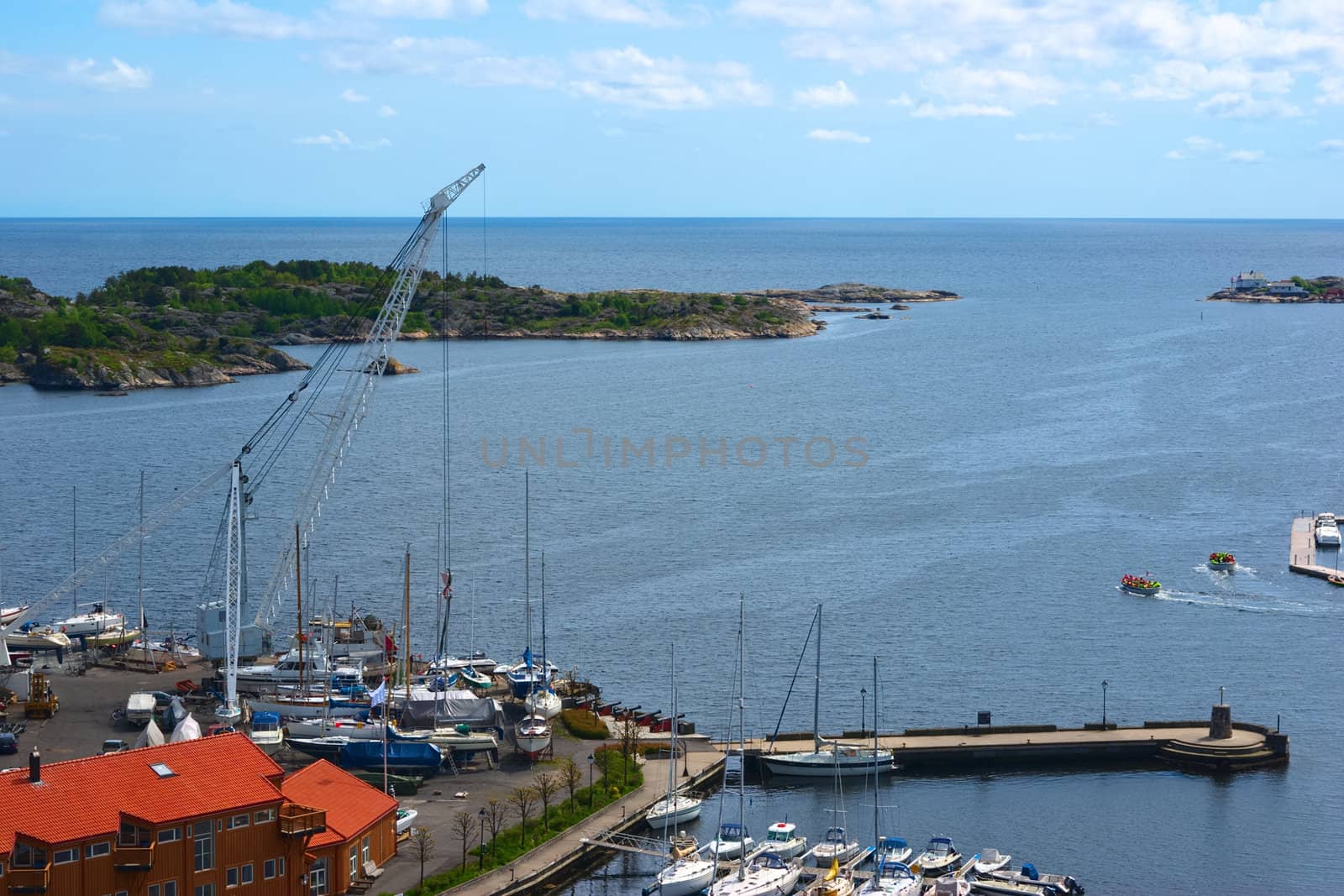 The marina with crane in Risor in Southern Norway