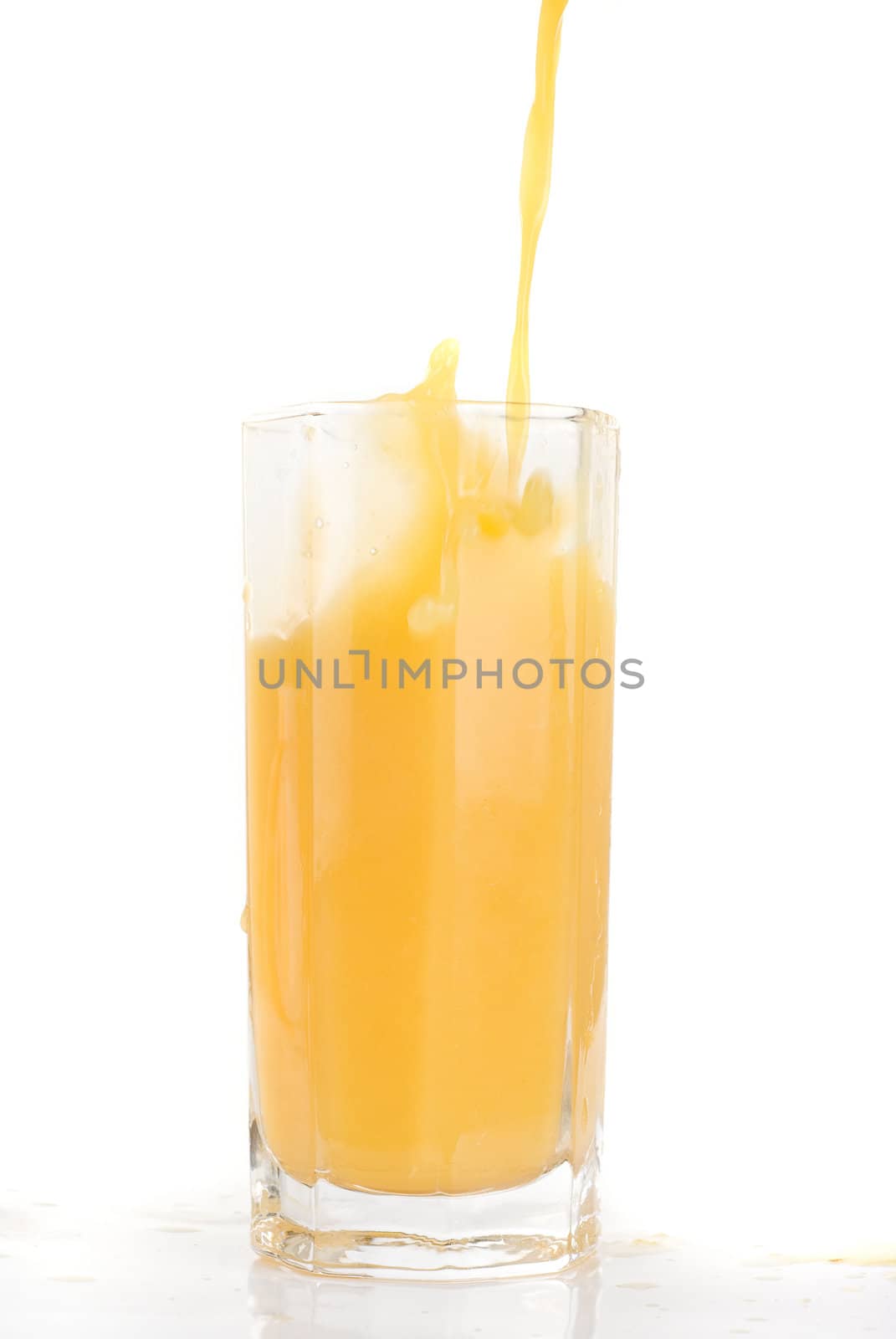 Fresh squeezed pouring orange juice isolated on a white background