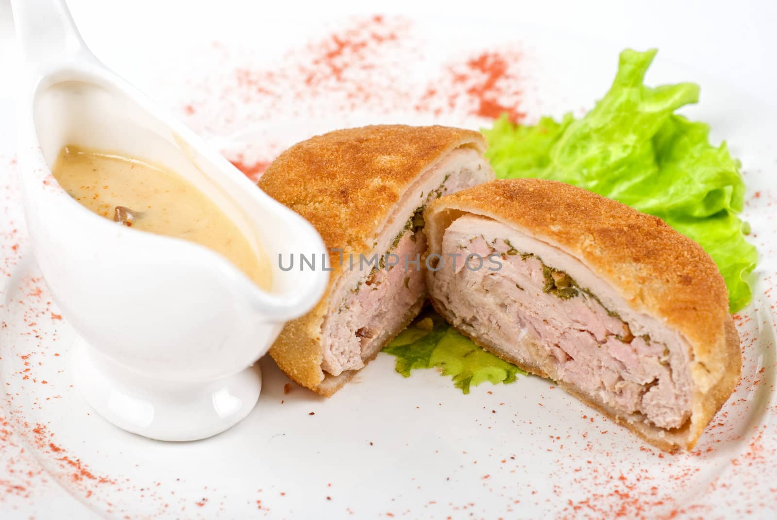 Beef cutlet closeup stuffed with bacon on white plate