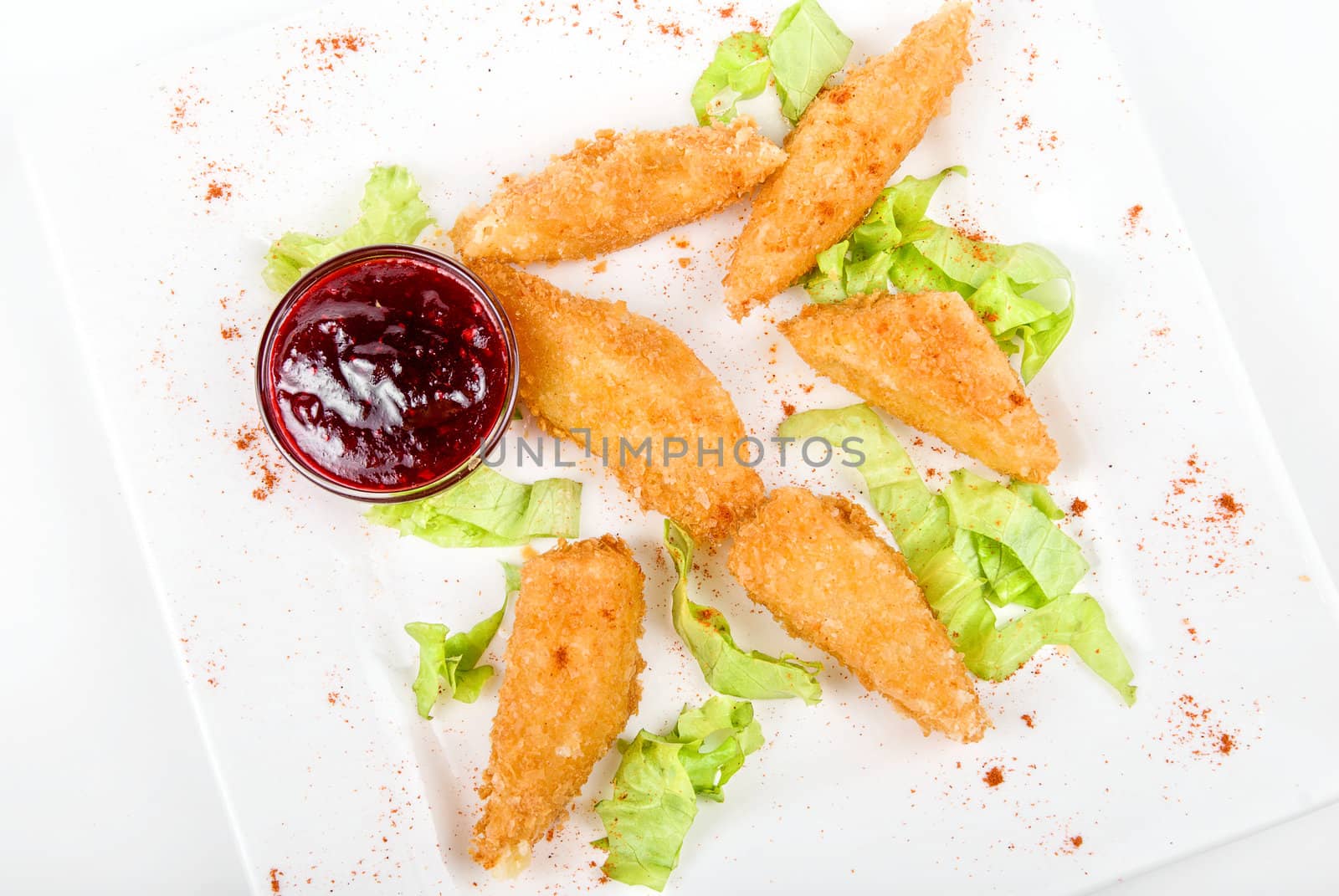 Tasty Baked cheese with cranberries sauce isolated on white