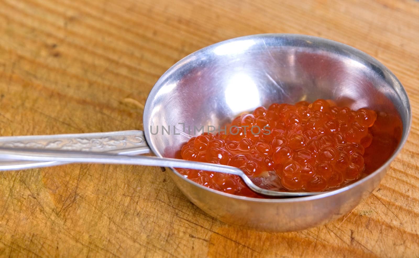 Red caviar closeup at wooden board