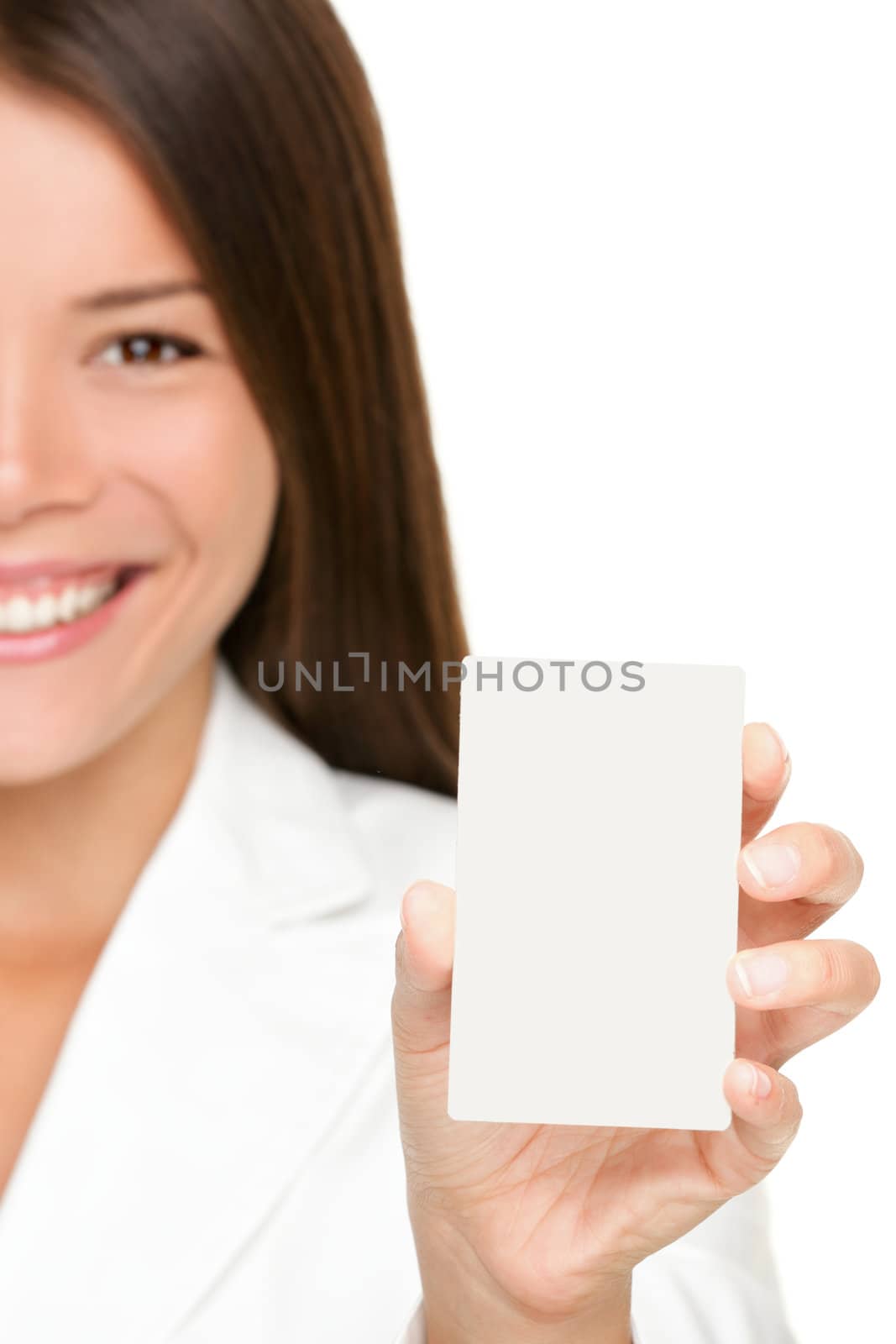 Woman showing business card. Businesswoman in suit holding blank card sign. Can be replaced with mobile phone or smart phone. Mixed race Asian / Caucasian business woman on white background in suit.