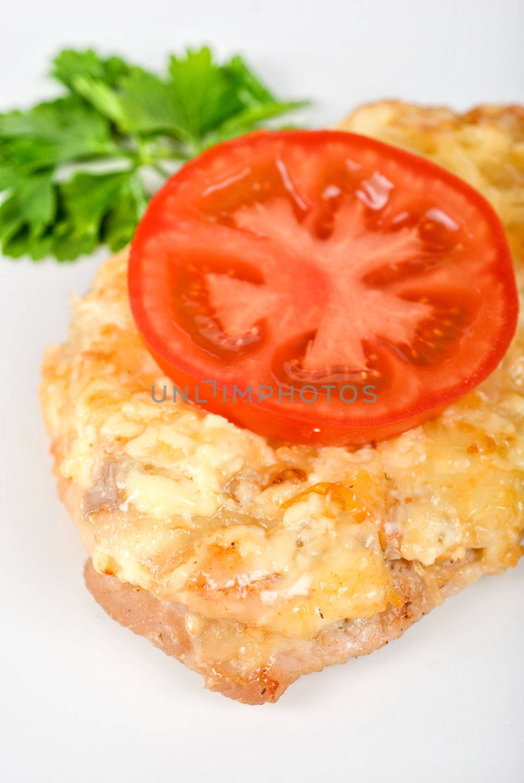 Roasted pork steak baked with cheese and tomato