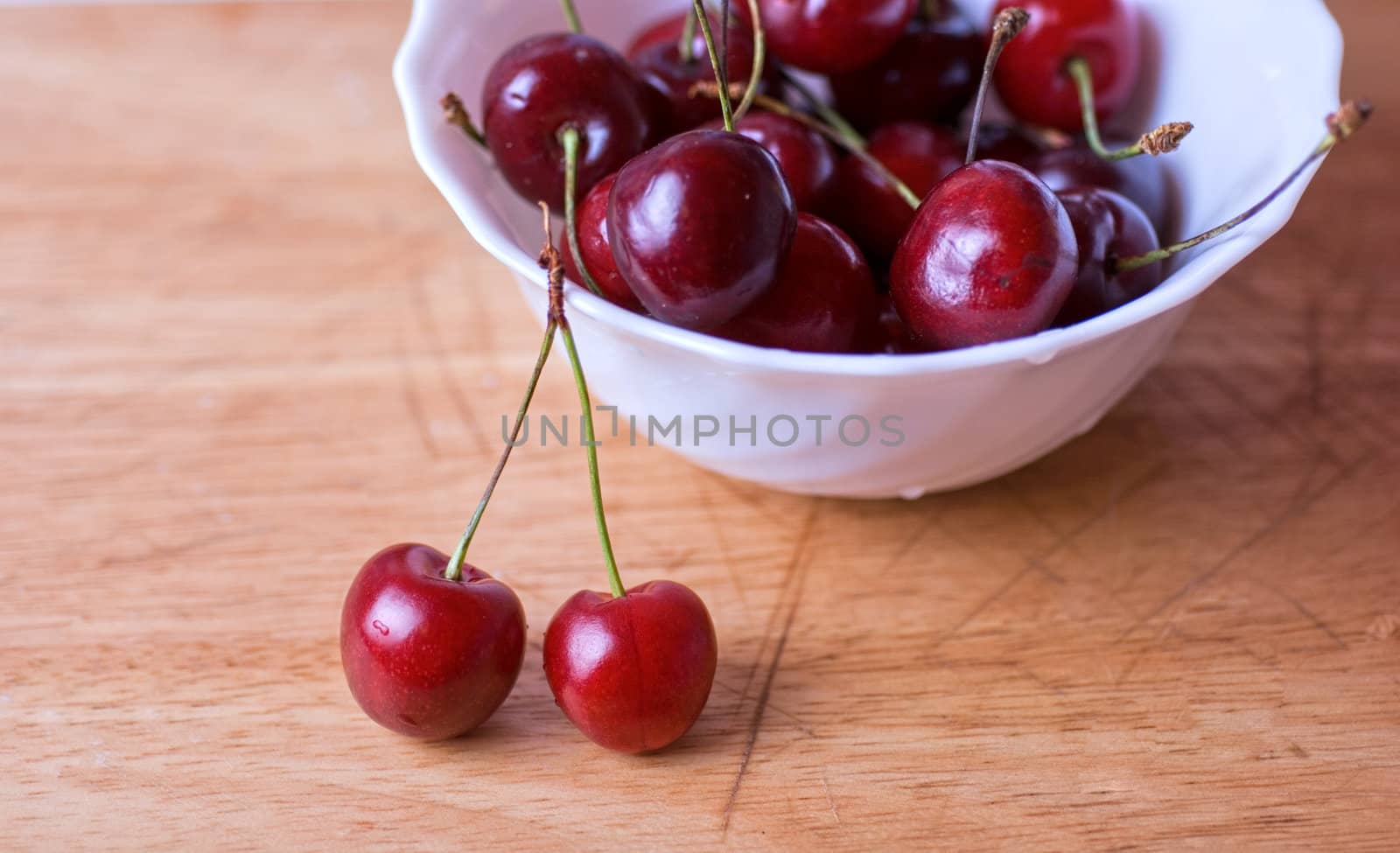 ripe cherries on the wood table