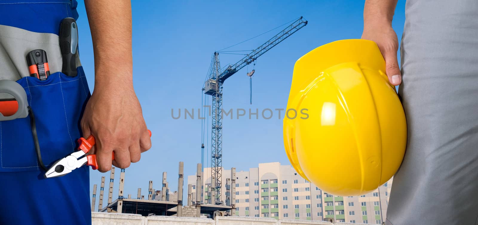 Closeup of workers with instruments on building background