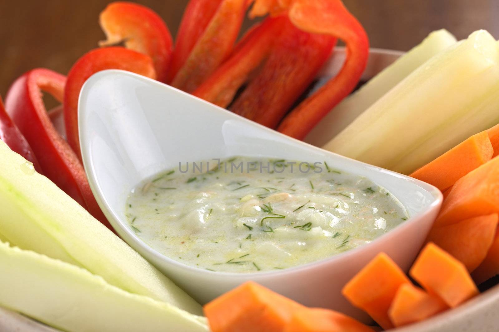 Fresh carrots, cucumbers and pepper with tzatziki dip (Selective Focus, Focus in the middle of the tzatziki)