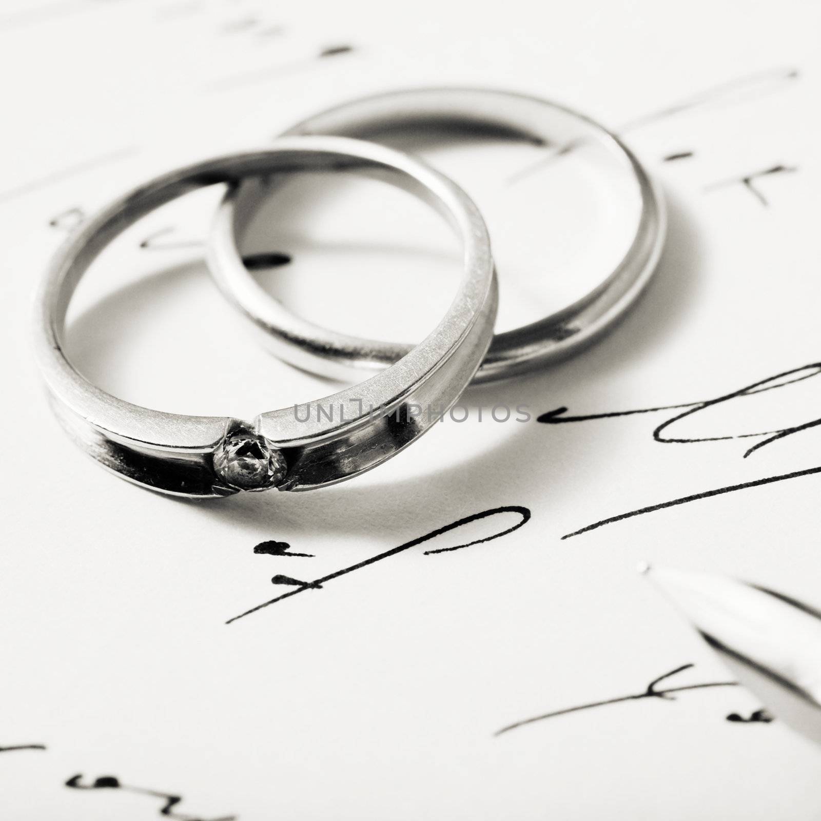 Stock photo: an image of two silver rings on a letter