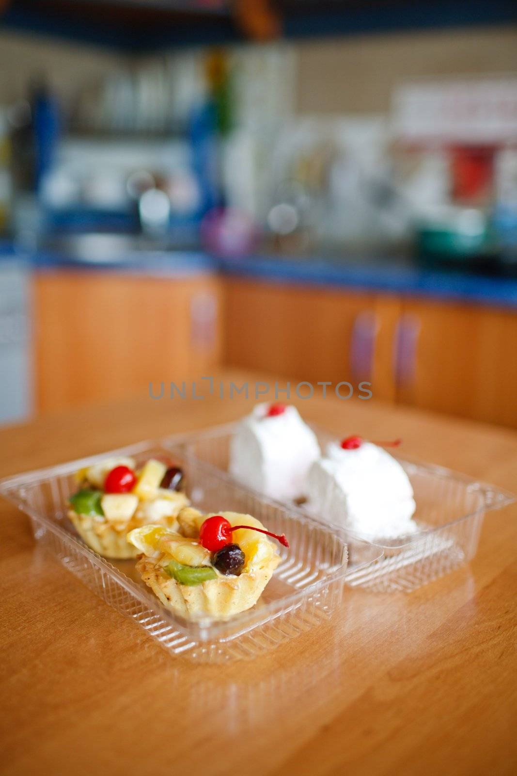 Cupcakes with cherry on top on wooden table. Make with Canon 35 1.4
aperture 1.4 was used for small DOF