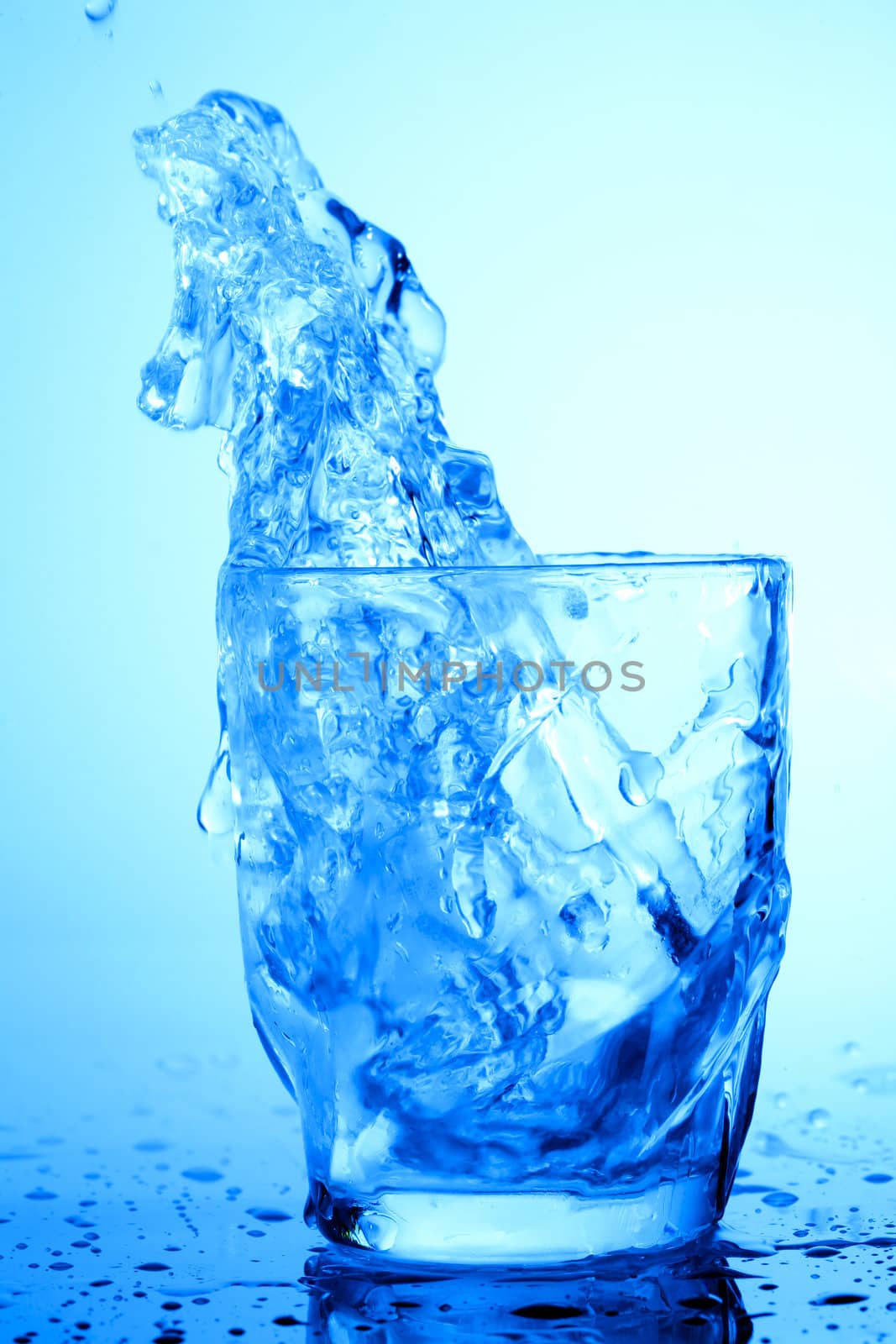 Stock photo: food theme: image of water splash in blue glass