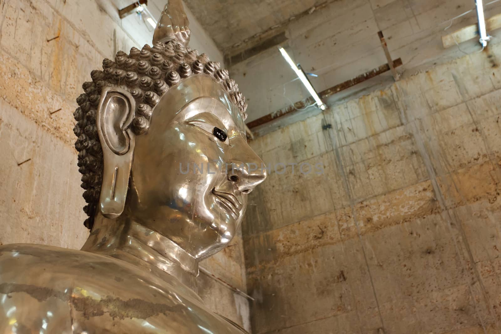 A tin buddha in temple at Ranong, Thailand.