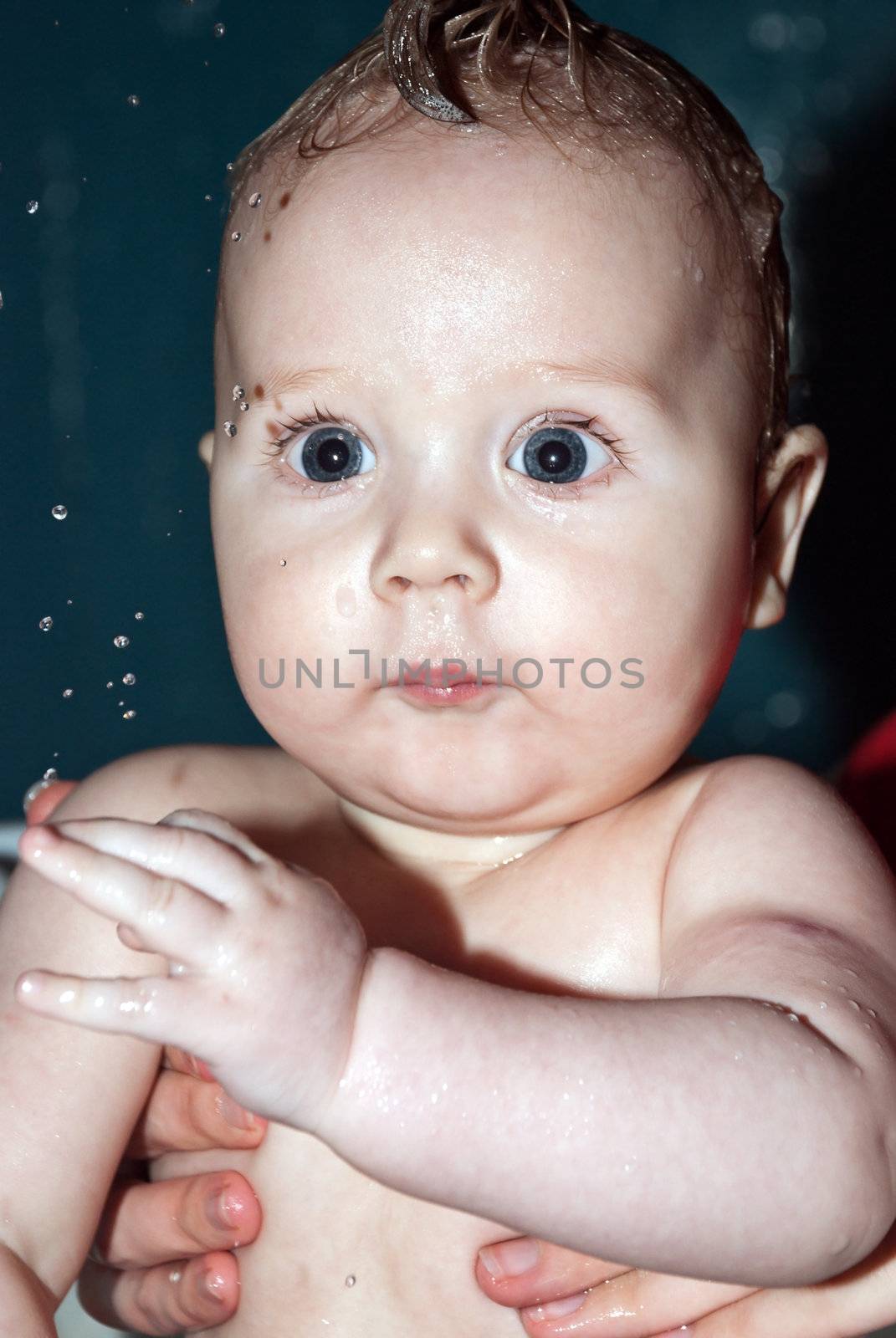 Bathing a cute little baby in the bath.