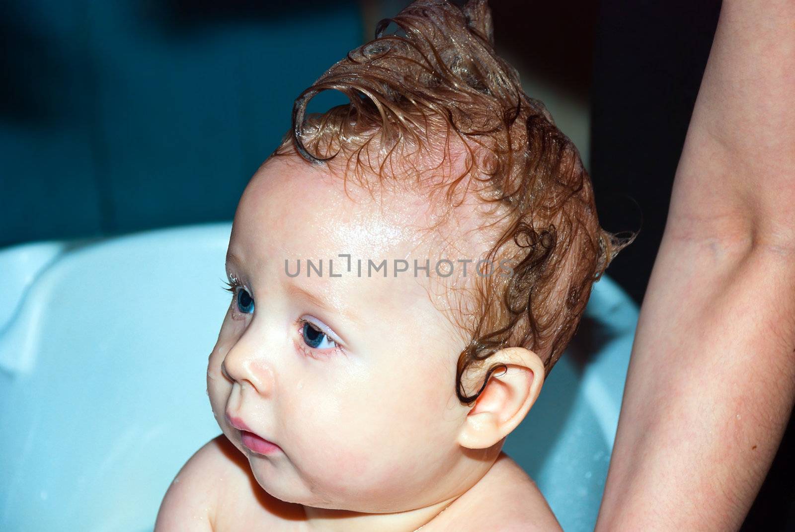 Bathing a cute little baby in the bath.