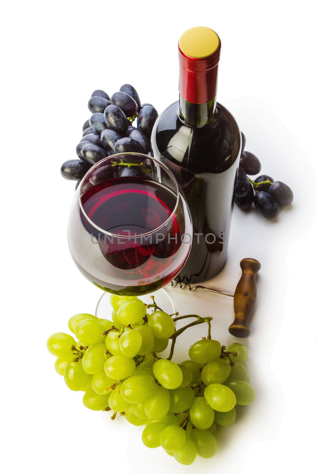 glass of red wine with bottle and grapes on a white background