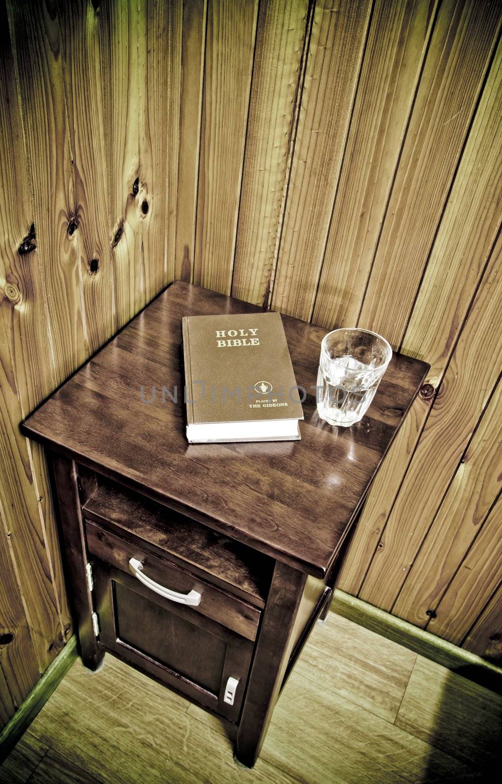 bible on bed side table in cheap hotel room