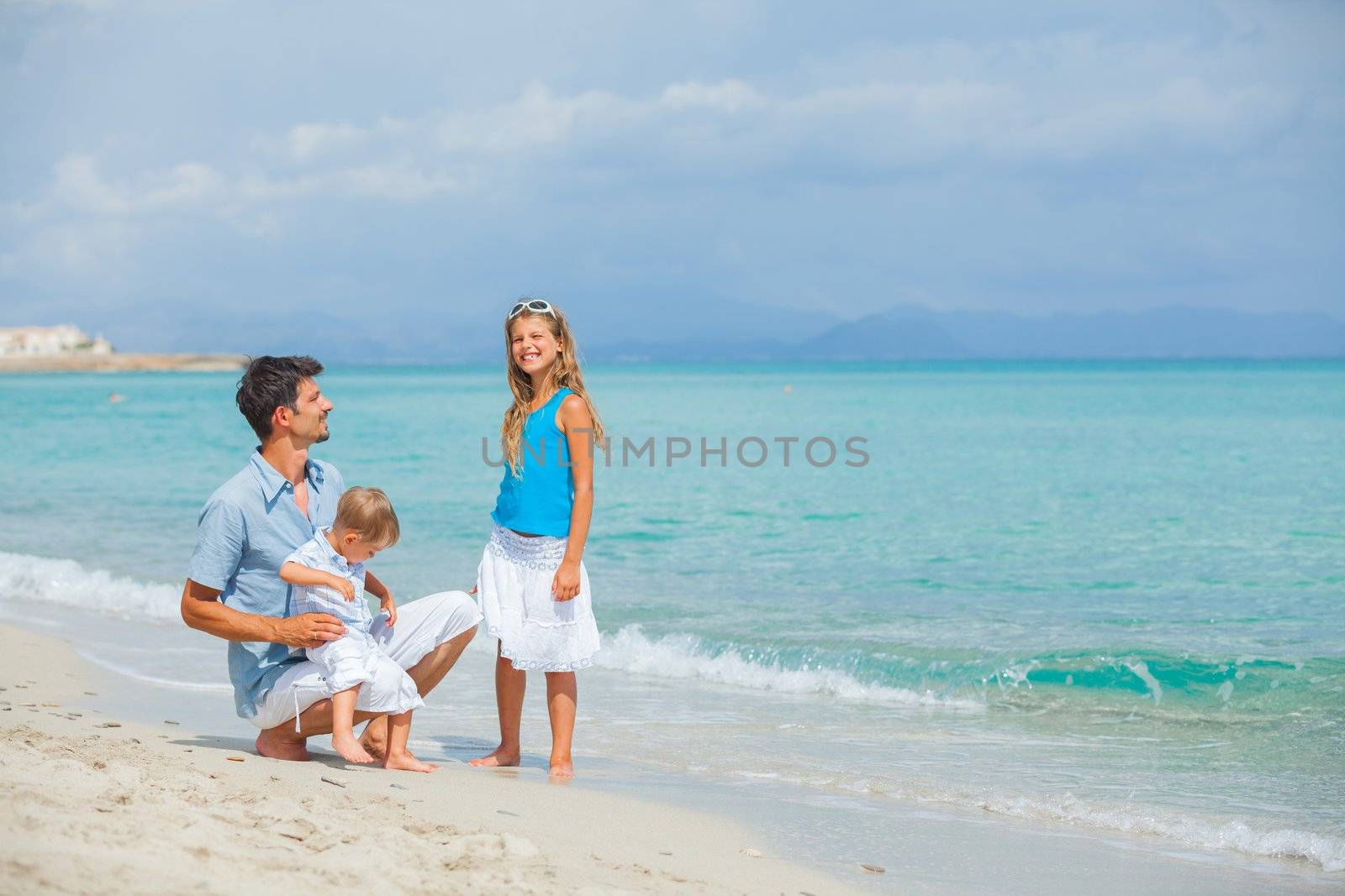 Father with her two kids on beach vacation by maxoliki