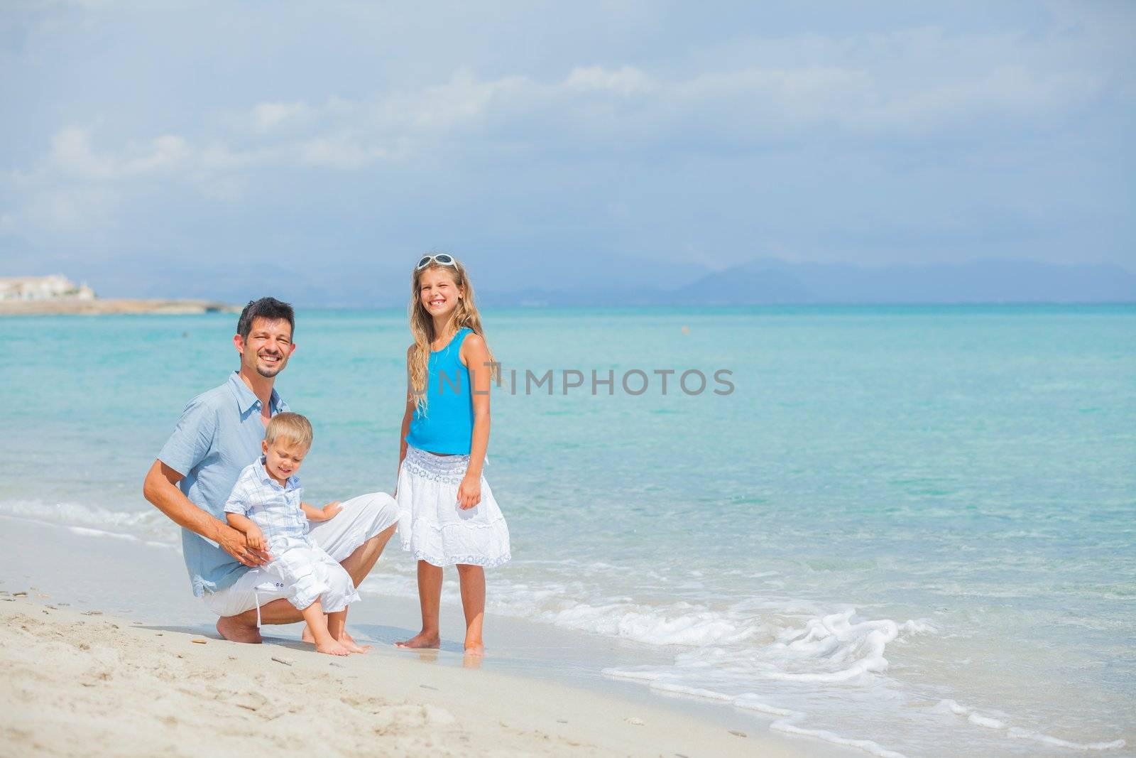 Young father with her two kids on tropical beach vacation