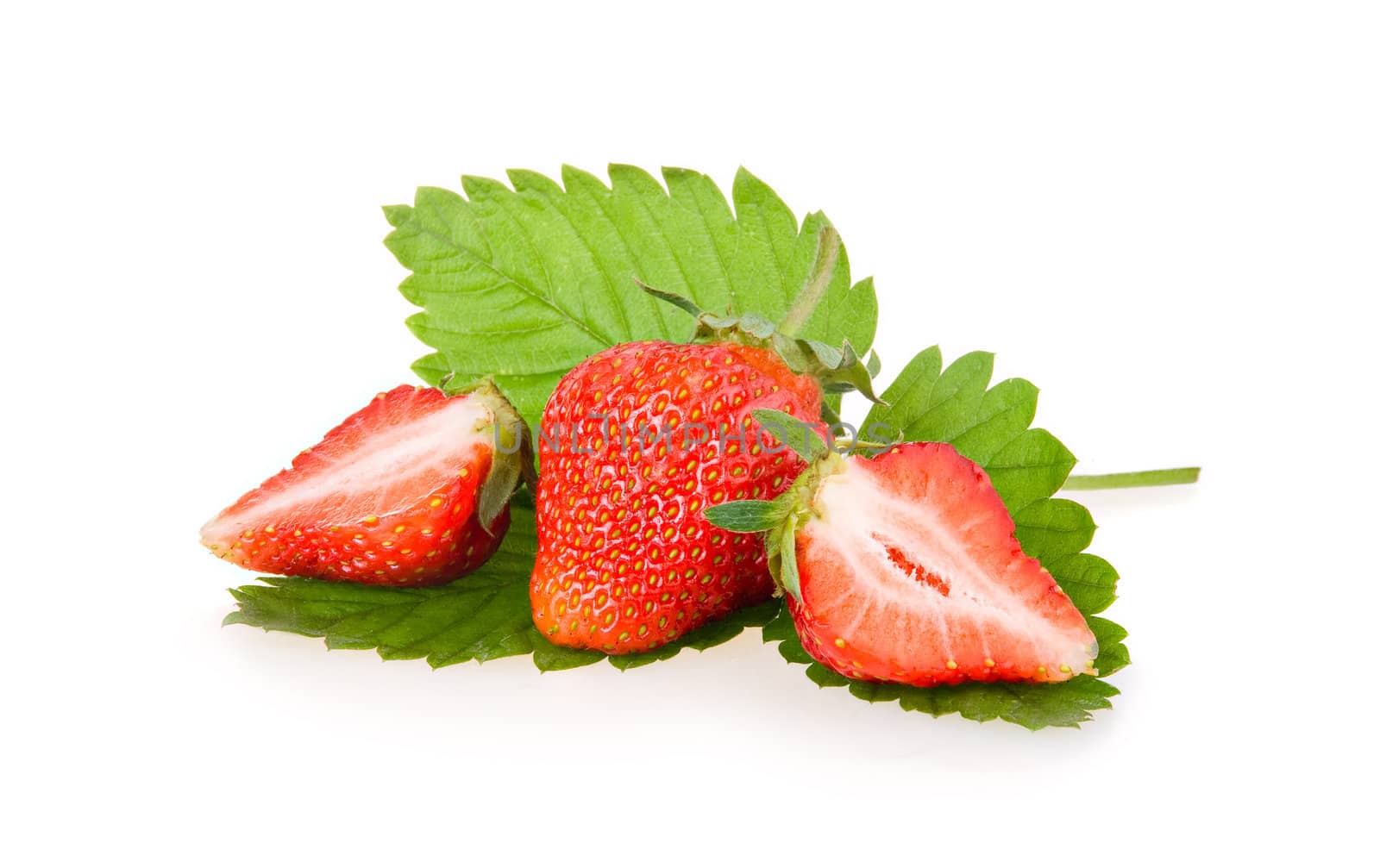 Red sliced strawberry fruits with green leaves isolated on white background 