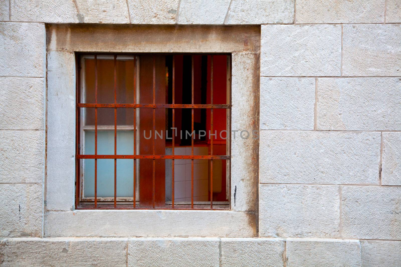 Window of brick building   with grating by motorolka