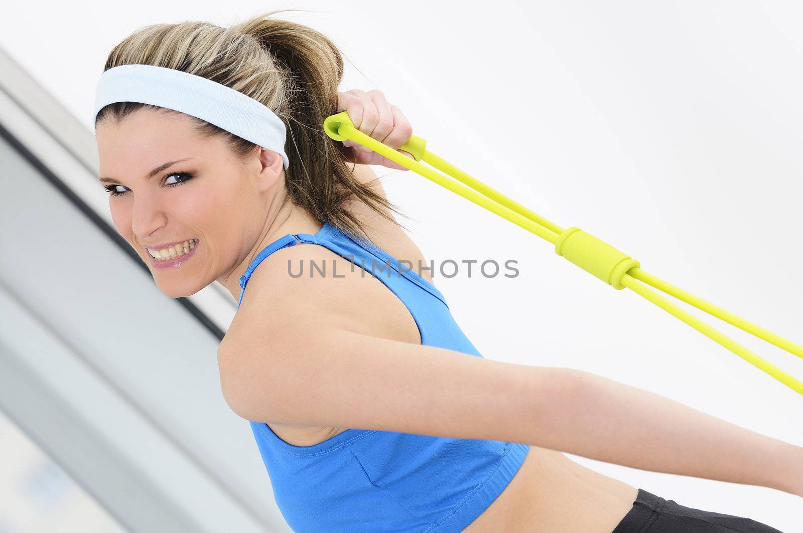 athletic woman doing gymnastic exercises with an elastic fitness