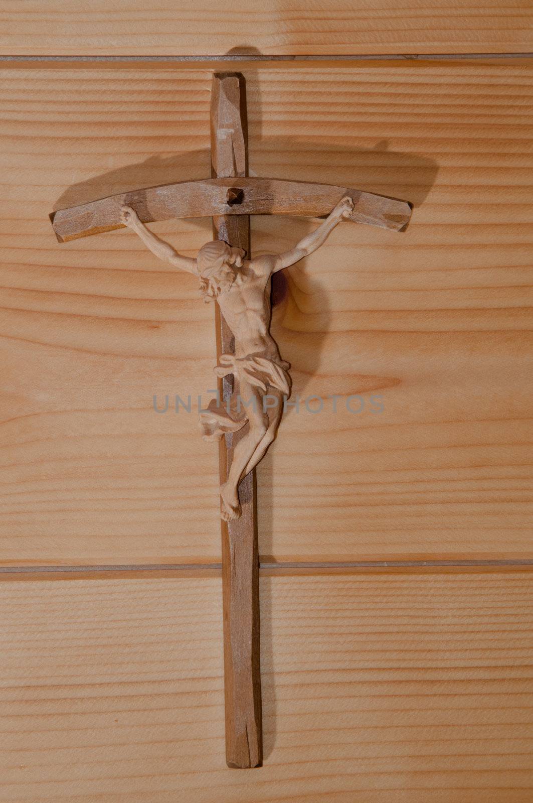 Wooden cross on a wooden wall in a cozy alpine cottage