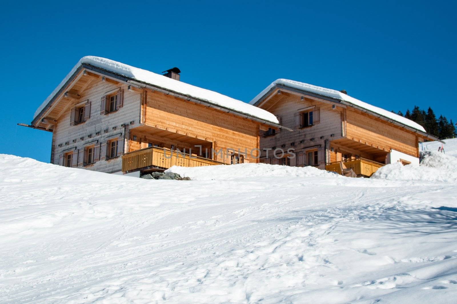 Wooden skiing huts covered with a lot of fresh snow in Montafon, Austria