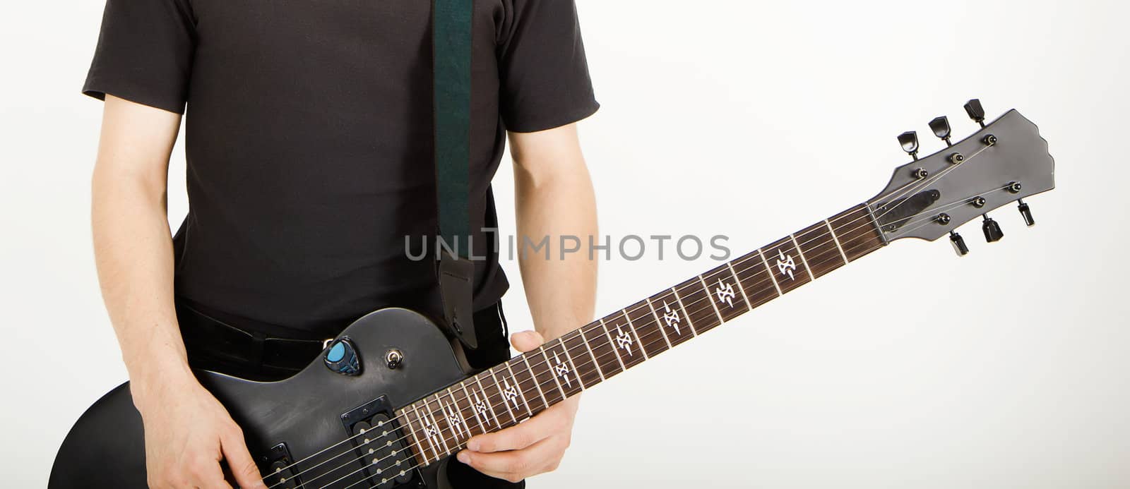 men's hands with a black guitar closeup