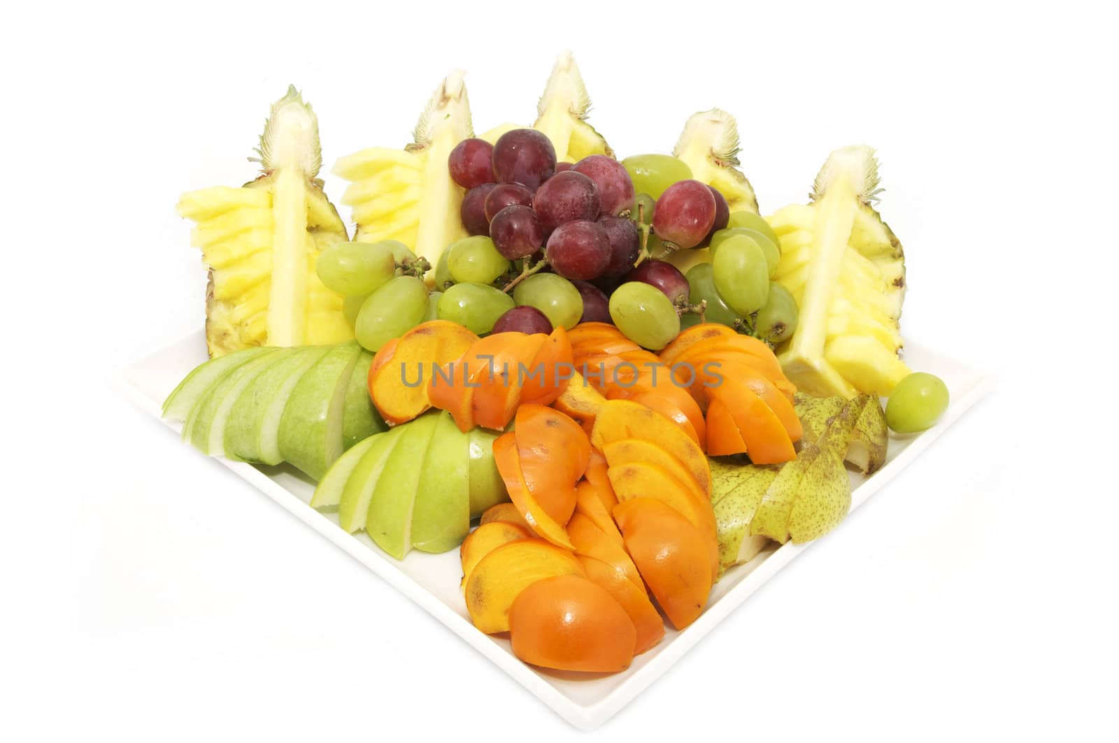 a large plate of sliced fruit on white background