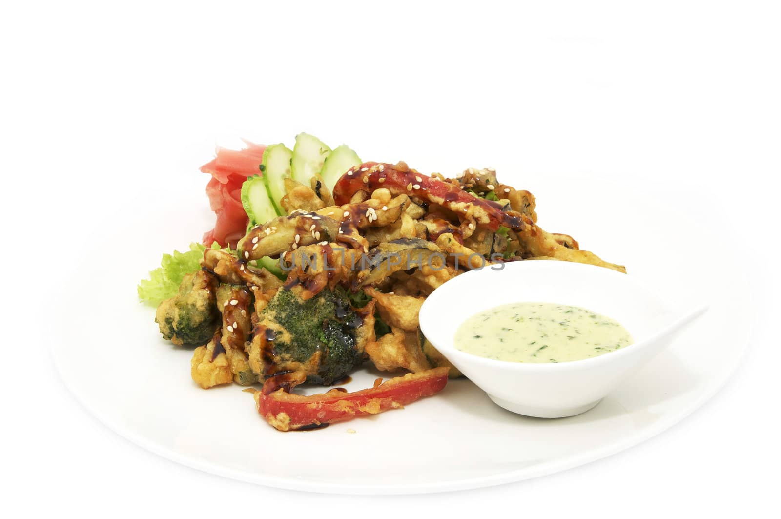 Vegetables in batter on a plate decorated with greens