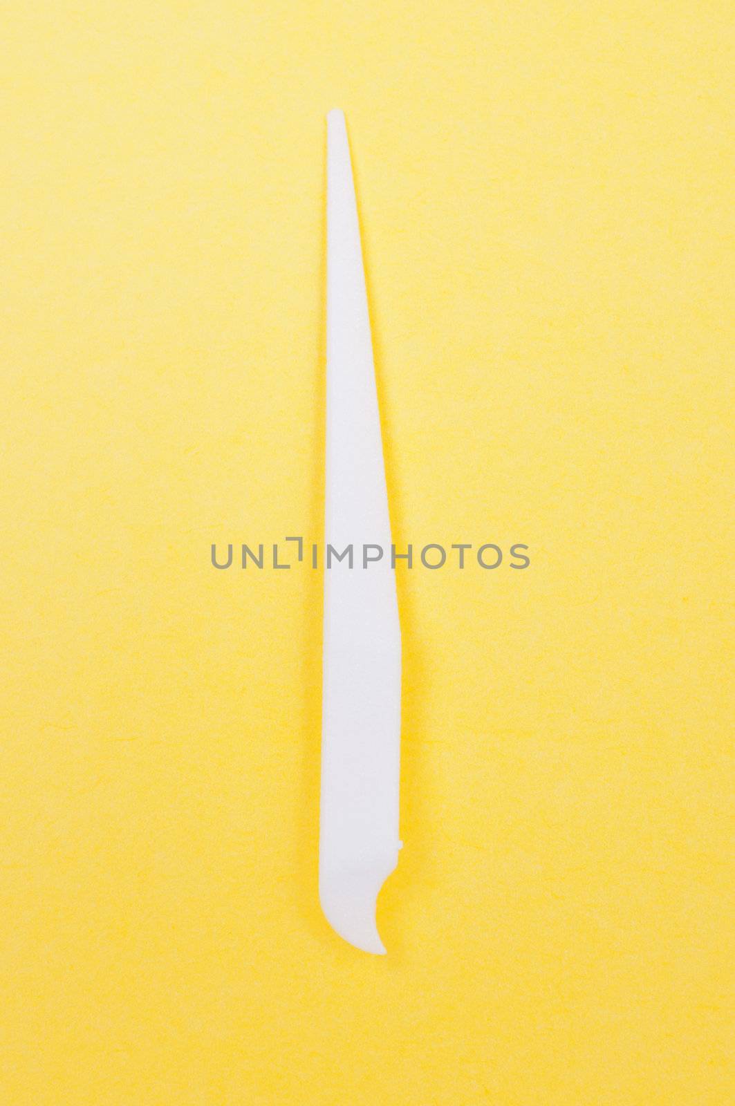 White toothpick on a yellow background close up