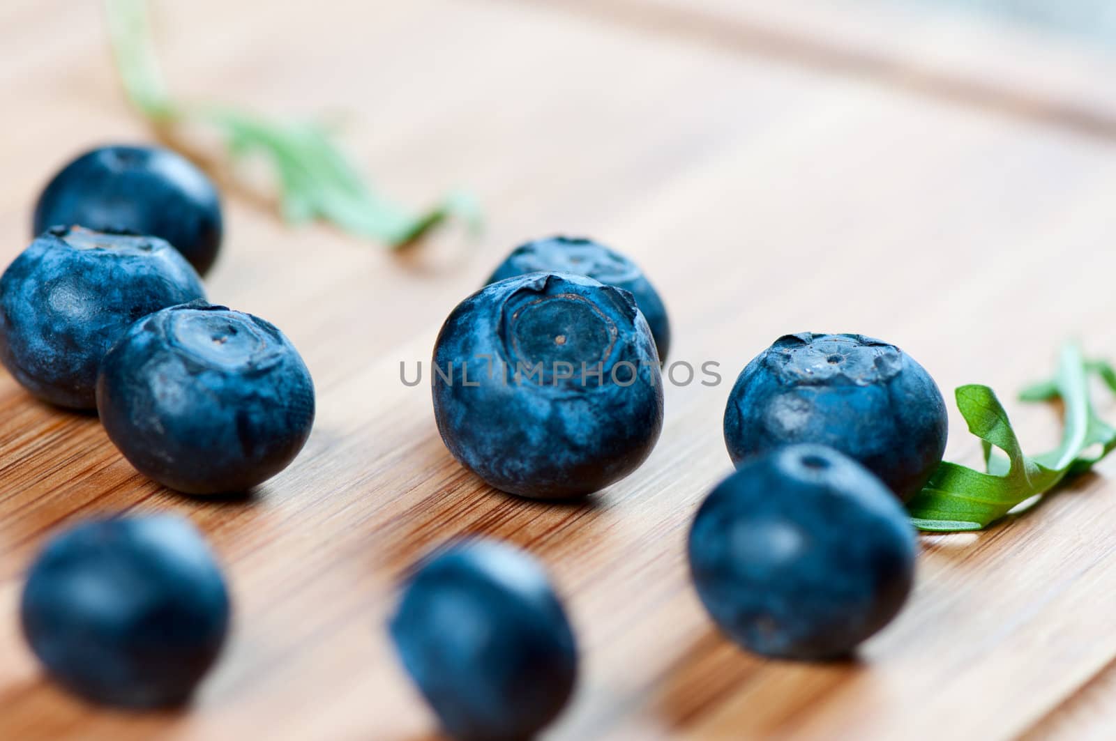 Large blueberries on a wooden board by Nanisimova