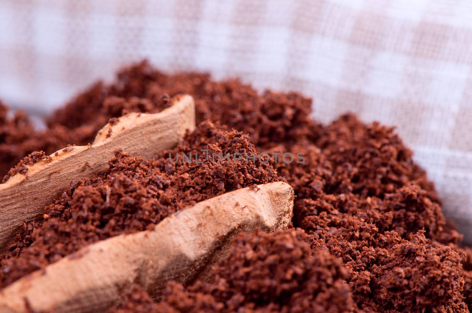 Ground coffee and wooden spoon close up