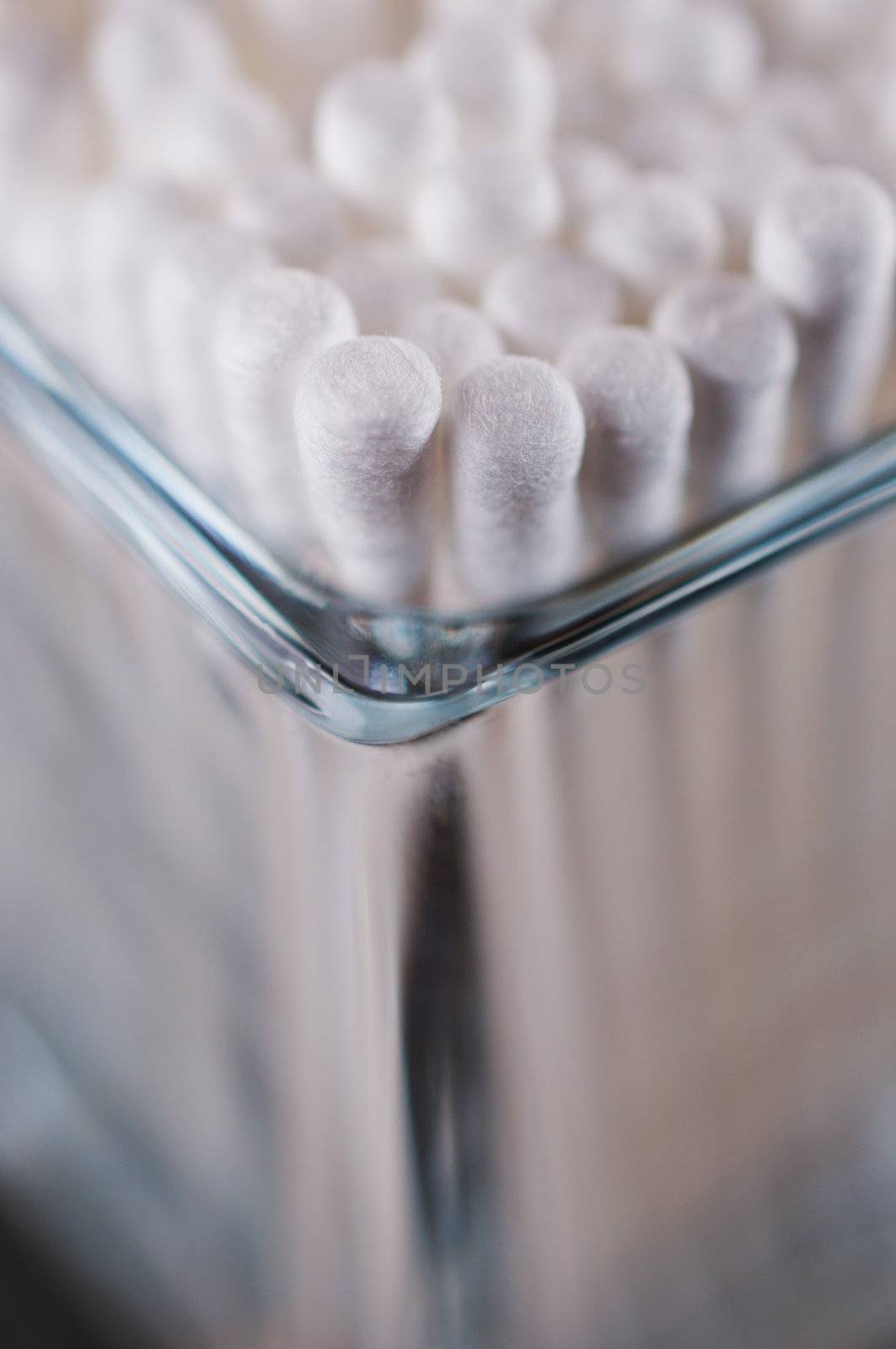Cotton buds in a glass corner view close up
