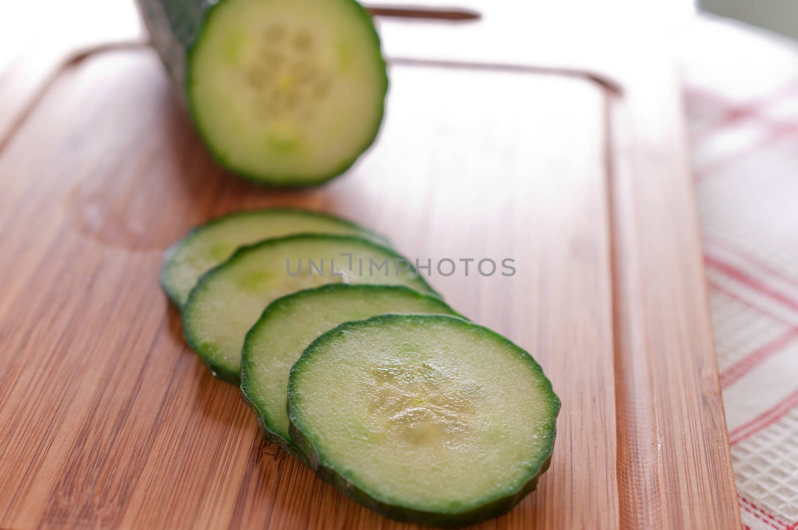 Sliced ​​cucumber on a wooden board