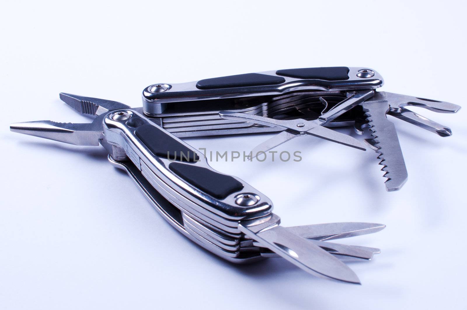 Fully unfolded multy tool on white background