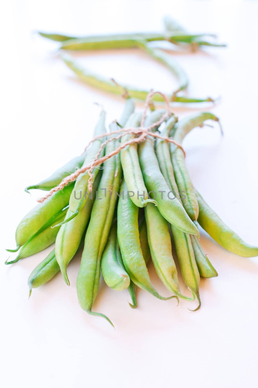 Green beans on white  by Nanisimova