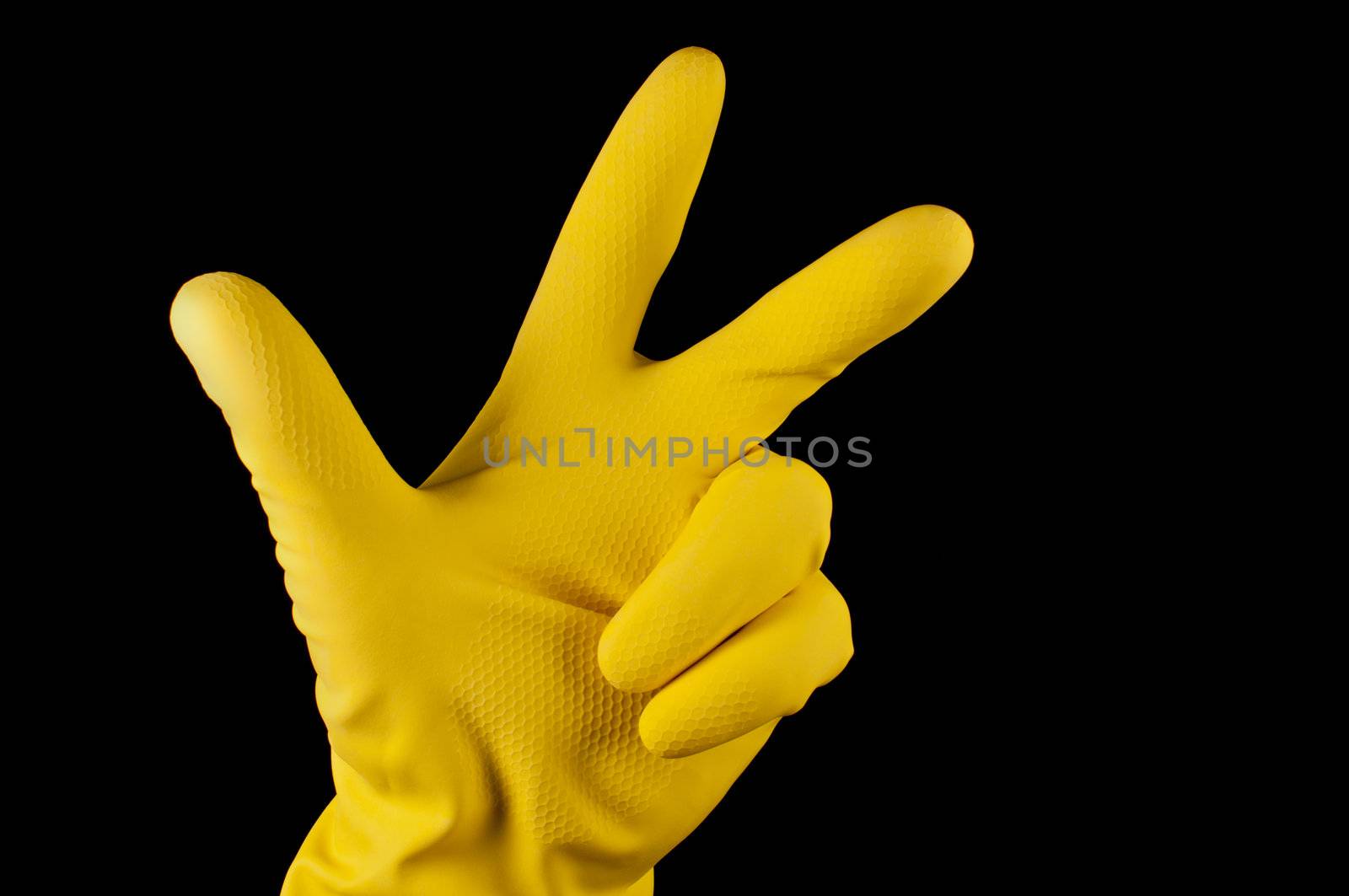 Hand in yellow glove making sign tree fingers on black background