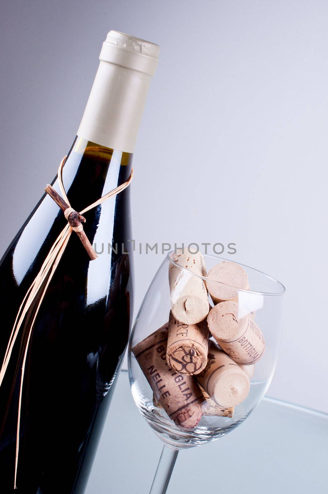 Wine bottle and glass full corks close up