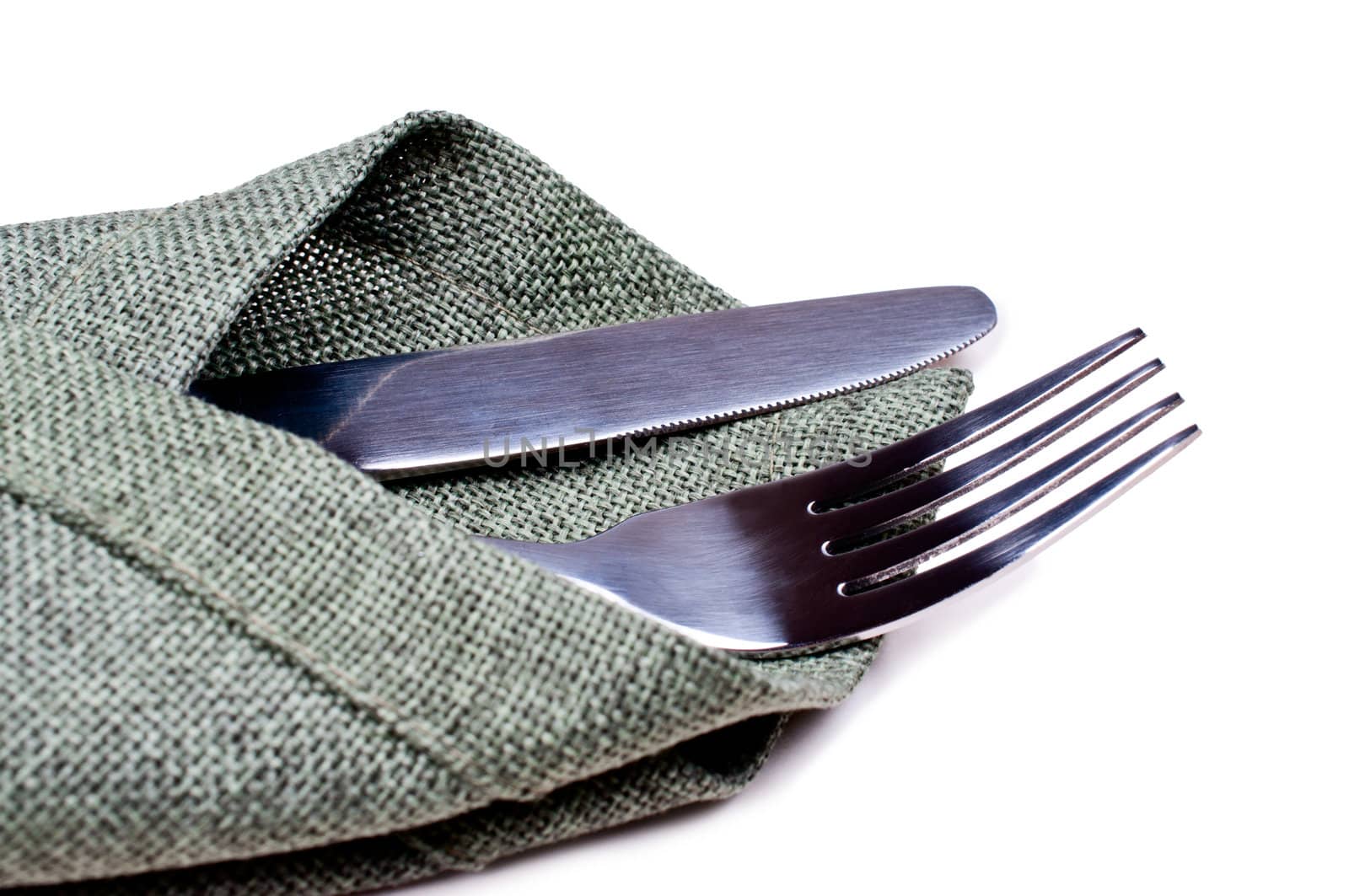 Knife and fork on green napkin close up by Nanisimova