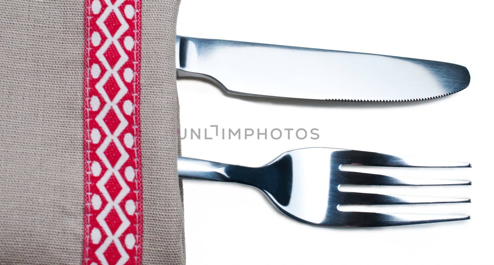 Knife and fork on gray napkin by Nanisimova
