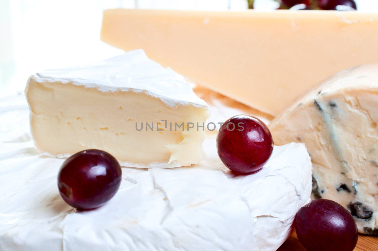 Brie parmesan and  blue cheese  with  grape