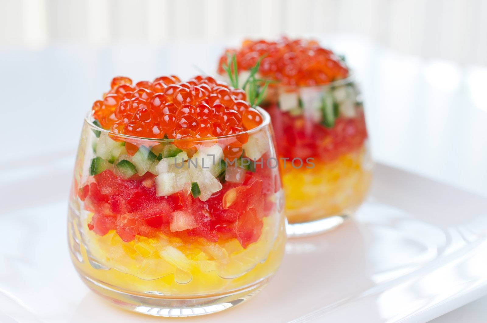 Caviar with vegetable salad in glasses