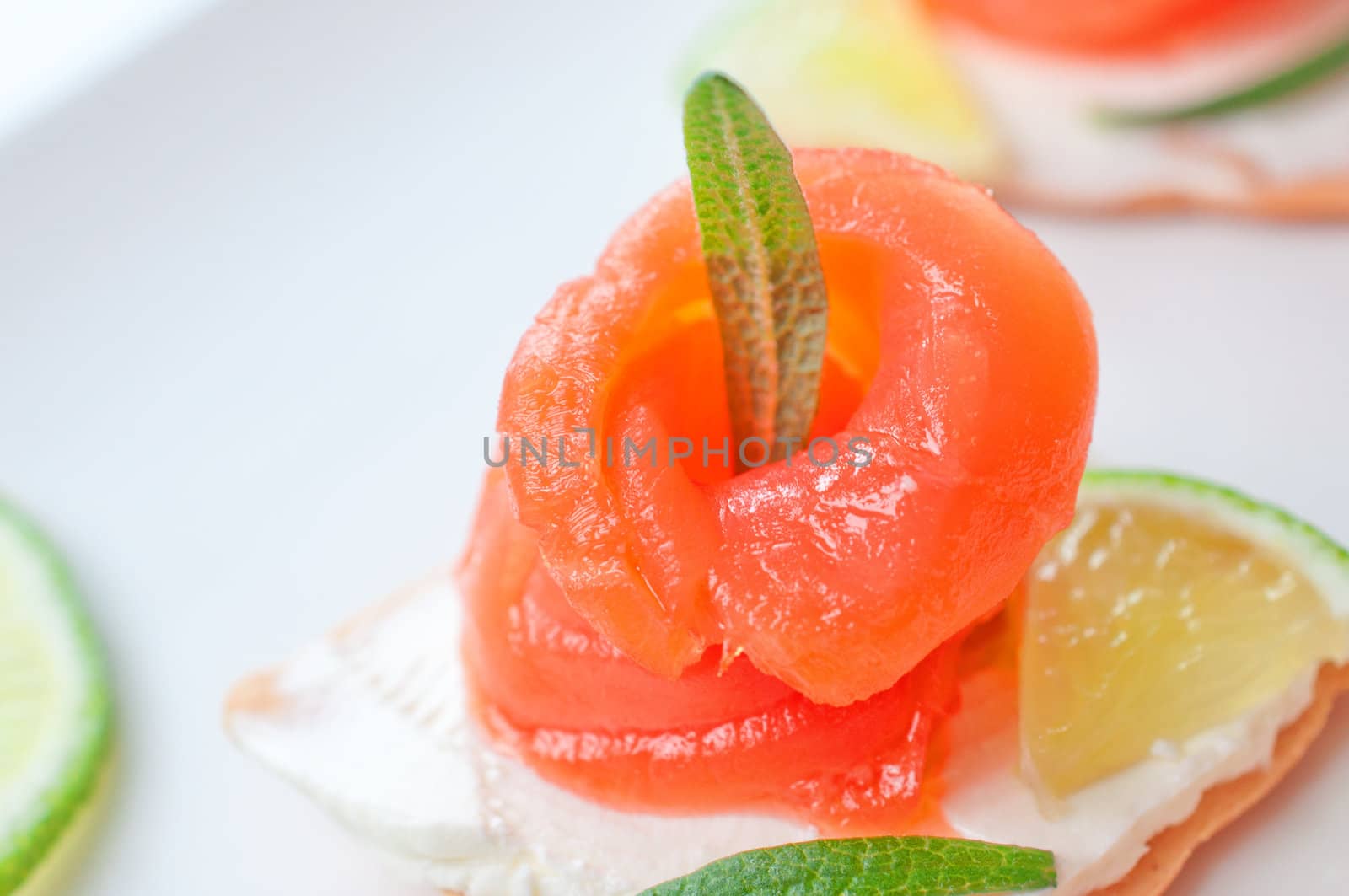 Canapes with smoked salmon and cream cheese on white by Nanisimova