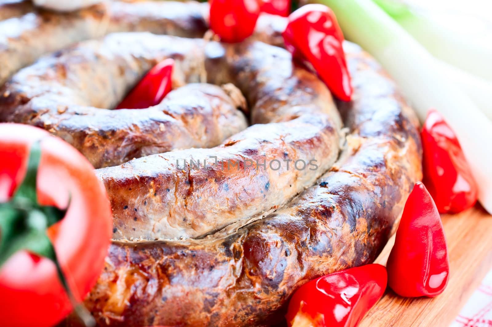 Sausage with tomatoes and  spices close up
