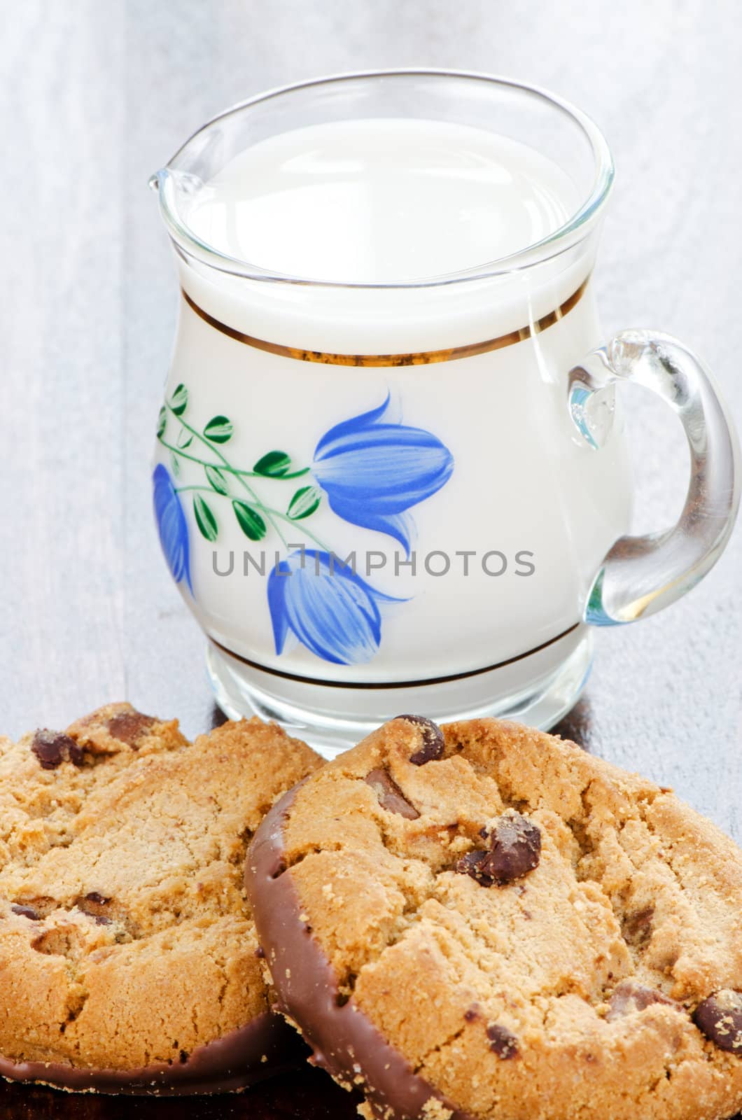 Сhocolate cookies and milk in jug by Nanisimova
