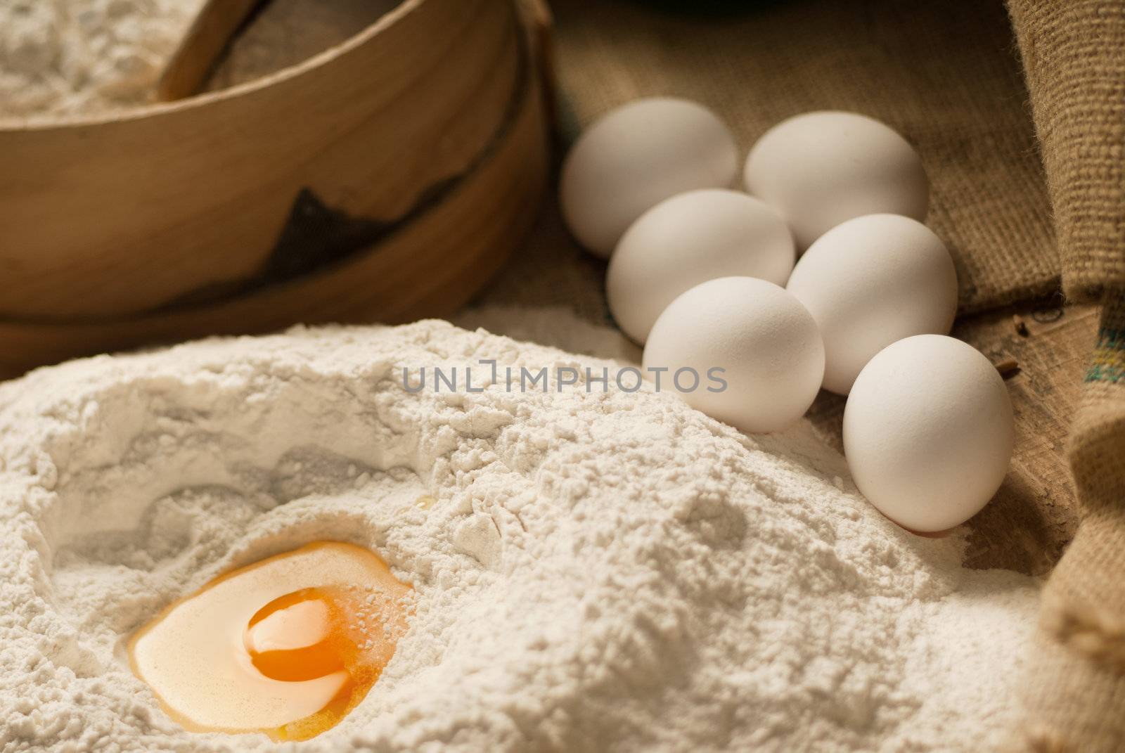 Egg yolk closeup in a heap of white flour