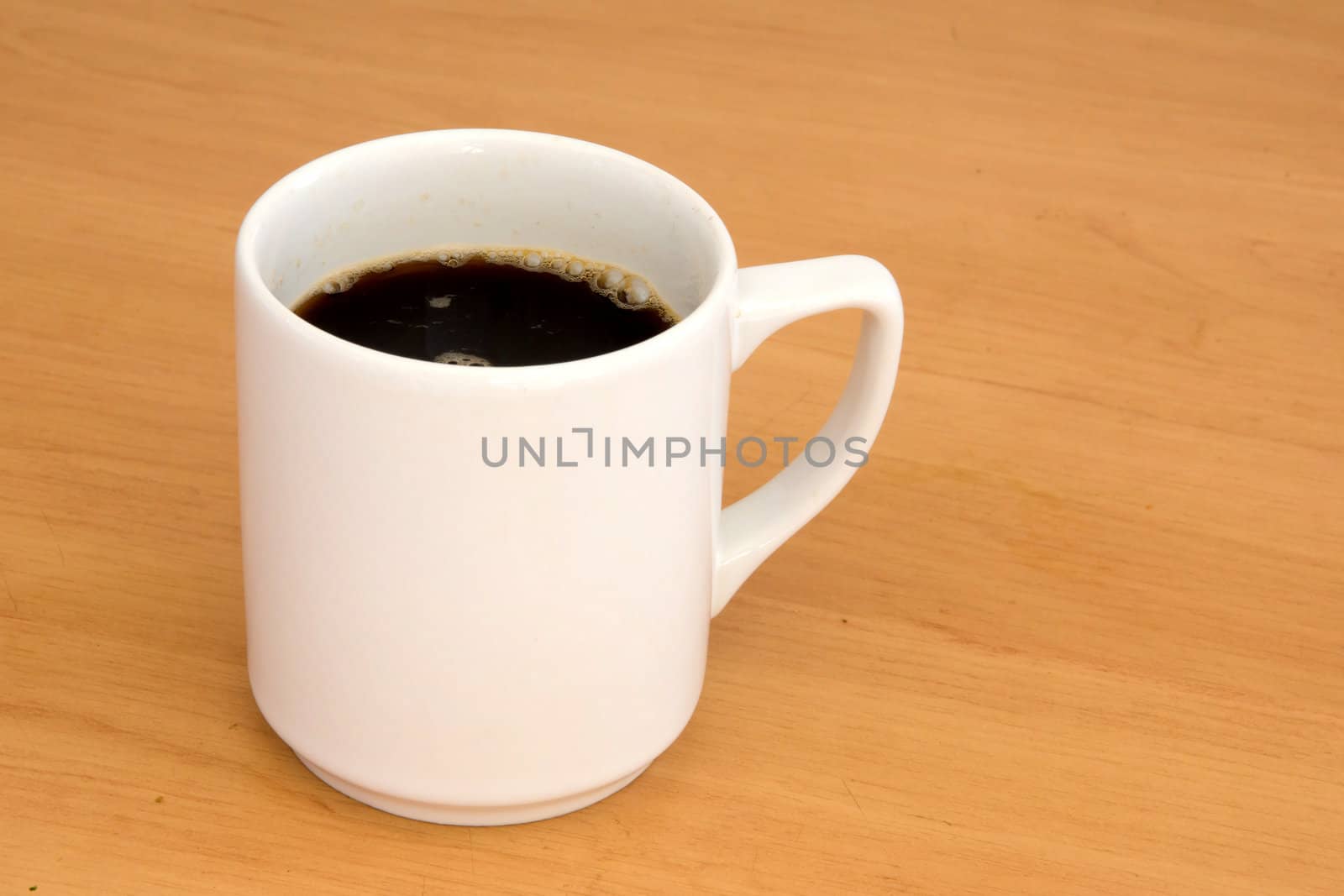 White coffe cup on a wooden table